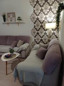 a living room with a couch and a table at Apartment Green Free private parking in Novi Sad