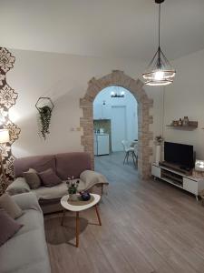 a living room with a couch and a table at Apartment Green Free private parking in Novi Sad