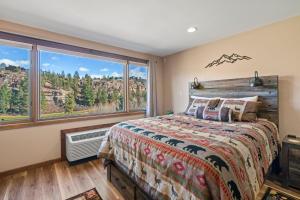 1 dormitorio con cama y ventana grande en NEW Tamarron Lodge unit-amazing views and 10 miles to Purgatory!, en Durango