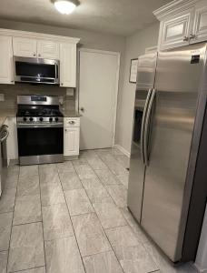 a kitchen with a stainless steel refrigerator and appliances at Amir Travels in Atlanta