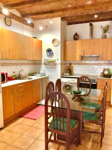 a kitchen with a glass table and wooden cabinets at Flat Plaza de España BCN in Barcelona