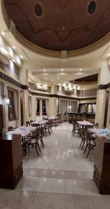 a restaurant with tables and chairs in a room at One bedroom Comfy Apartment by the sea, in Oriental Coast in Marsa Alam City