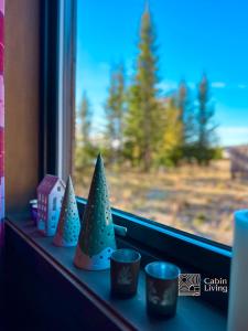 a window sill with some christmas decorations on it at Cozy apartment ski in out, BBQ & Wifi Sjusjøen in Sjusjøen
