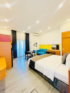 a hotel room with a large bed and a desk at Khem Beach serviced apartment in Phú Quốc