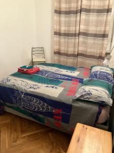 a bed sitting in a room with a table at Casa Ciotti Appartamento in centro ad Aosta CIR 0124 in Aosta
