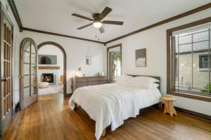 a bedroom with a bed and a ceiling fan at Relaxing Gingerbread House -TU/Expo Sq/ Route 66 in Tulsa