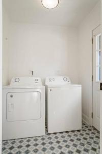 two white washers and dryers in a white room at Relaxing Gingerbread House -TU/Expo Sq/ Route 66 in Tulsa