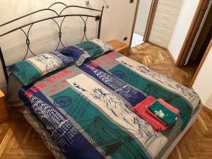 a bed with a comforter and pillows on it at Casa Ciotti Appartamento in centro ad Aosta CIR 0124 in Aosta