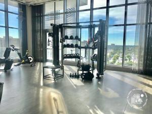 a gym with a view of a city at Luxury apartment with endless ocean views -Daily resort fee and parking not included- in Hollywood