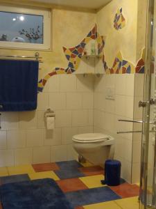 a bathroom with a toilet and a blue towel at Ferienwohnung Frühauf in Prien am Chiemsee