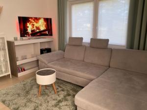a living room with a couch and a tv at Ferienhaus Damian in Cuxhaven