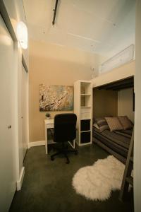 a bedroom with a desk and a bed and a desk chair at 2 Full Beds, Free Parking Underground Heated, Rogers Place, 1 Bedroom Condo Downtown Central in Edmonton