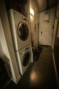a laundry room with a washer and dryer at 2 Full Beds, Free Parking Underground Heated, Rogers Place, 1 Bedroom Condo Downtown Central in Edmonton