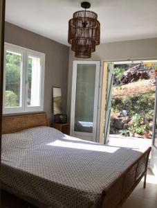 a bedroom with a bed and a large window at Vido bene in Vidauban