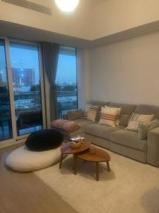 a living room with a couch and a table at Modern 1 Bedroom Apartment Yas island with private beach in Abu Dhabi +8 photos