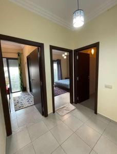 a hallway with two doors and a room with a bed at أكادير in Agadir