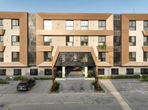 a building with a car parked in a parking lot at Luxury Almalqa شقة فاخرة الملقا in Riyadh