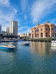 a group of boats in the water in a city at Casa Chloé - vicino al Porto e Basilica San Nicola in Bari