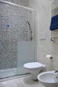 a bathroom with a shower and a toilet and a sink at Casa Chloé - vicino al Porto e Basilica San Nicola in Bari +33 photos