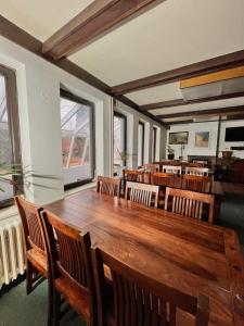 a dining room with a large wooden table and chairs at Vila Morava in Liptovský Mikuláš