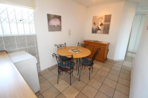 a kitchen with a table and chairs in a room at Providence 79 in Uvongo Beach