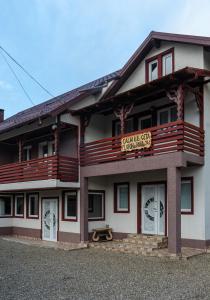 a building with a sign for a hotel at Casa Calin in Câmpulung Moldovenesc