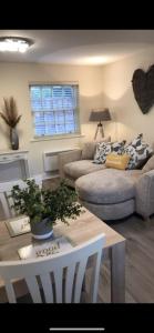 a living room with a couch and a table at 2 Bedroom duplex apartment in Bawtry