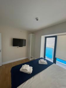 a bedroom with a bed and a flat screen tv at Apart Otel Orbi City in Batumi