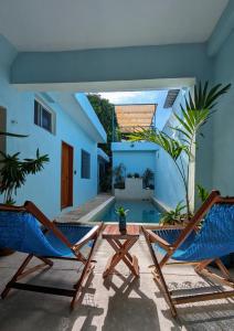 a patio with two chairs and a swimming pool at Casa Aguazul in Campeche