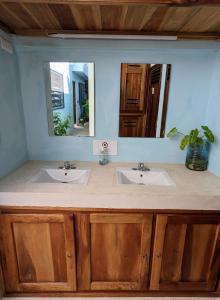 a bathroom with two sinks and a mirror at Casa Aguazul in Campeche