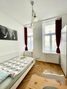 a bedroom with a bed and two windows at Centra and simple to reach in Vienna
