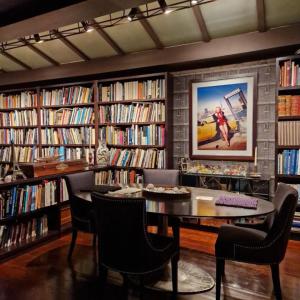 a library with a table and chairs and books at Marbella Boutique Art suites in Marbella
