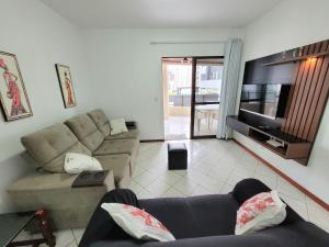 ein Wohnzimmer mit 2 Sofas und einem Flachbild-TV in der Unterkunft Apartamento 200 metros da praia 03 quartos com ar condicionado - Meia Praia - Itapema in Itapema