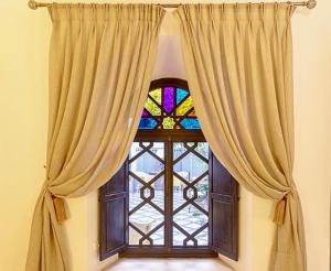 a large window with a stained glass window at Riad Zouhour in Marrakech