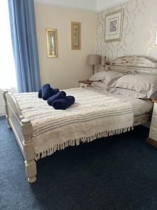 a bedroom with a bed with blue towels on it at Harbour View Ground Floor Flat with Private Parking, only 5 Mins walk to harbour in Brixham