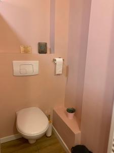 a bathroom with a white toilet and a toilet paper dispenser at The home Privacy in Marseille