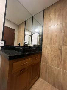 uma casa de banho com um lavatório e um espelho em Hotel Backdoor em Imbituba
