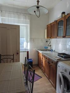 a kitchen with a sink and a washing machine at Petrova Steet Abode in Zagreb