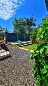 einen Garten mit einer Mauer und einem Park in der Unterkunft Casa confortable con pileta para 2 personas - Rincón Posadas in Posadas