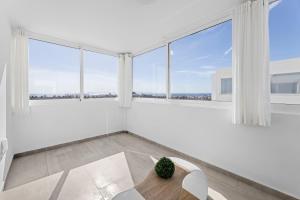 a white room with a table and large windows at Villa Atlántica - Heated pool in Playa Blanca in Playa Blanca