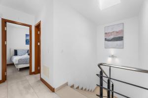 a hallway with a staircase leading to a bedroom at Villa Atlántica - Heated pool in Playa Blanca in Playa Blanca