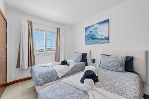 a bedroom with two beds with stuffed animals on them at Villa Atlántica - Heated pool in Playa Blanca in Playa Blanca