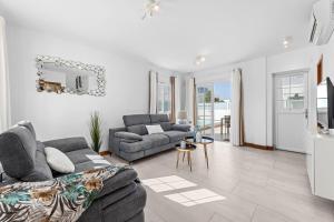 a living room with two couches and a table at Villa Atlántica - Heated pool in Playa Blanca in Playa Blanca