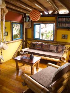 a living room with a couch and a table at Simply Paradise in Mompiche