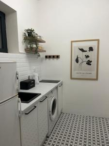 a kitchen with a washer and dryer in it at Central Park Apartment in Novi Sad