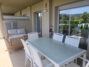 a blue table and chairs in a room with a window at Luxury La Cala Golf Haven with terrace & pool in La Cala de Mijas
