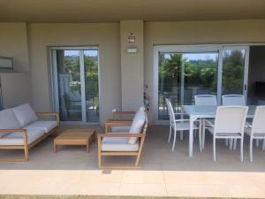 a patio with a table and chairs and a dining room at Luxury La Cala Golf Haven with terrace & pool in La Cala de Mijas