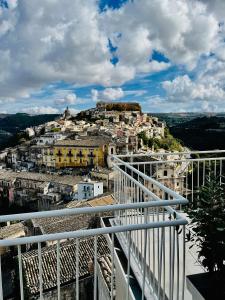 a view of a city from the balcony of a building at La casa di Irene - Suites con vista in Ragusa