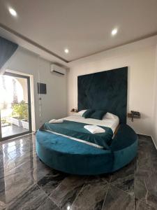 a large bed in a room with a large blue bedvisor at Luxury Resort in Licola