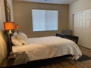 a bedroom with a bed with a table and a window at Luxurious Condo at the Springs by Cool Properties in Mesquite